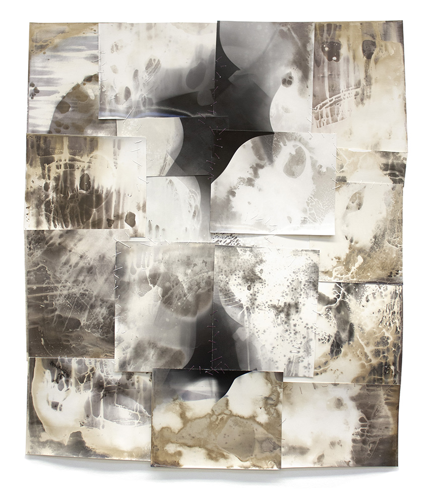 An abstract image made of earth tones and sewn sheets of gelatin silver photo paper